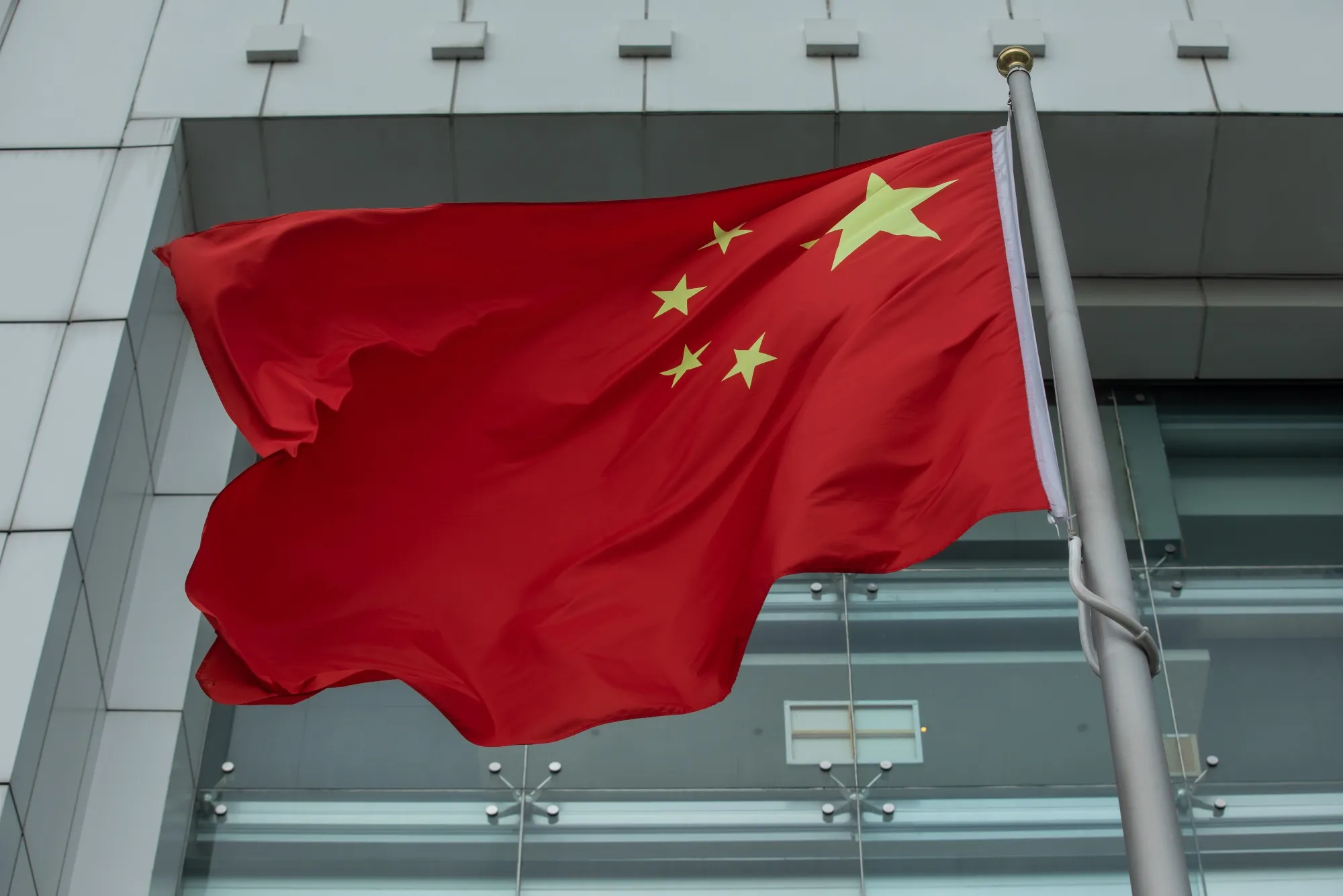 The Chinese flag flies in front of the Liaison Office of the Central People's Government in Hong Kong.