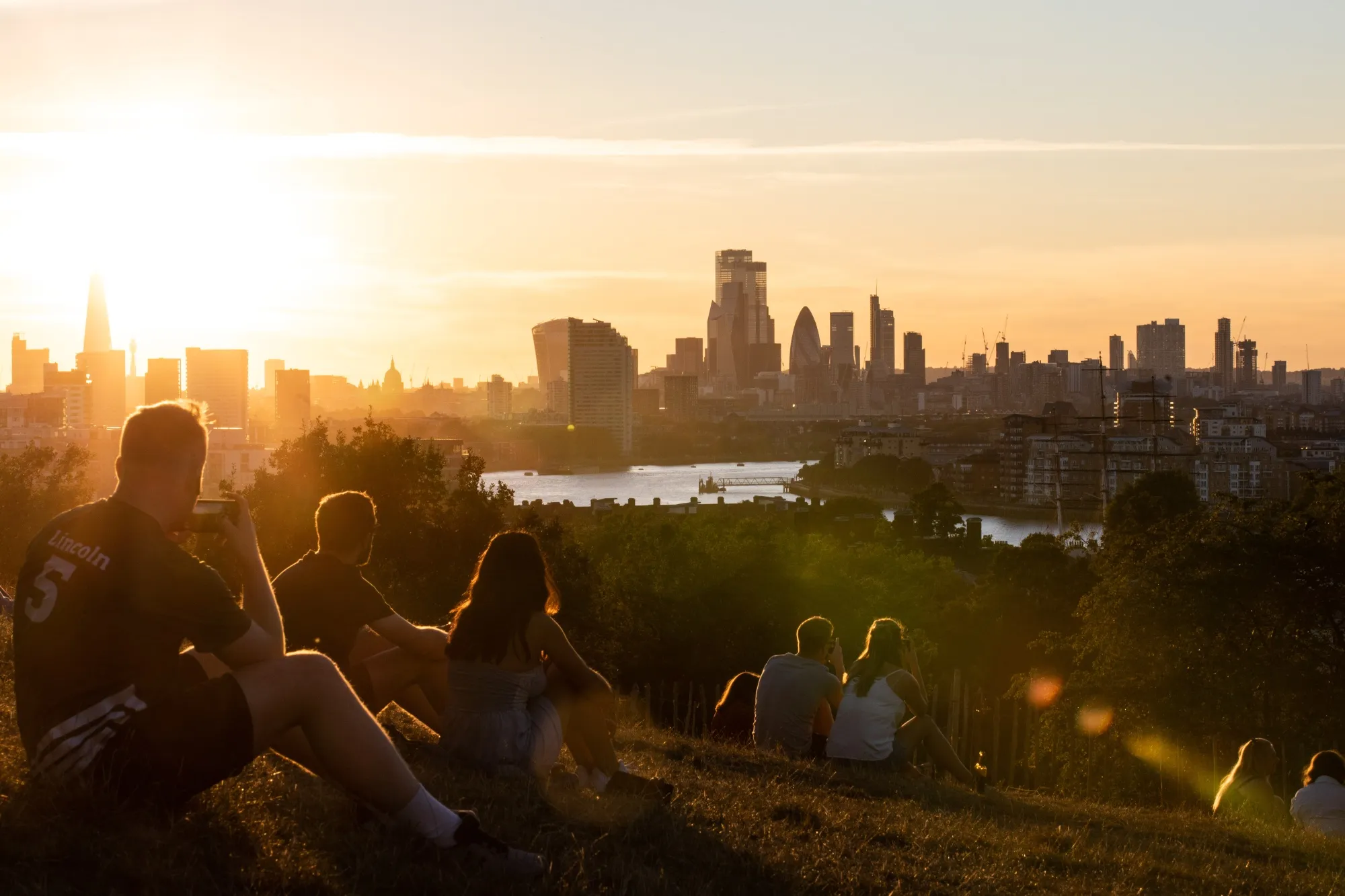 People&nbsp;gather in a park in London.