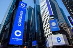 Monitors display Coinbase signage during the company's initial public offering (IPO) at the Nasdaq MarketSite in New York, U.S., on Wednesday, April 14, 2021. 