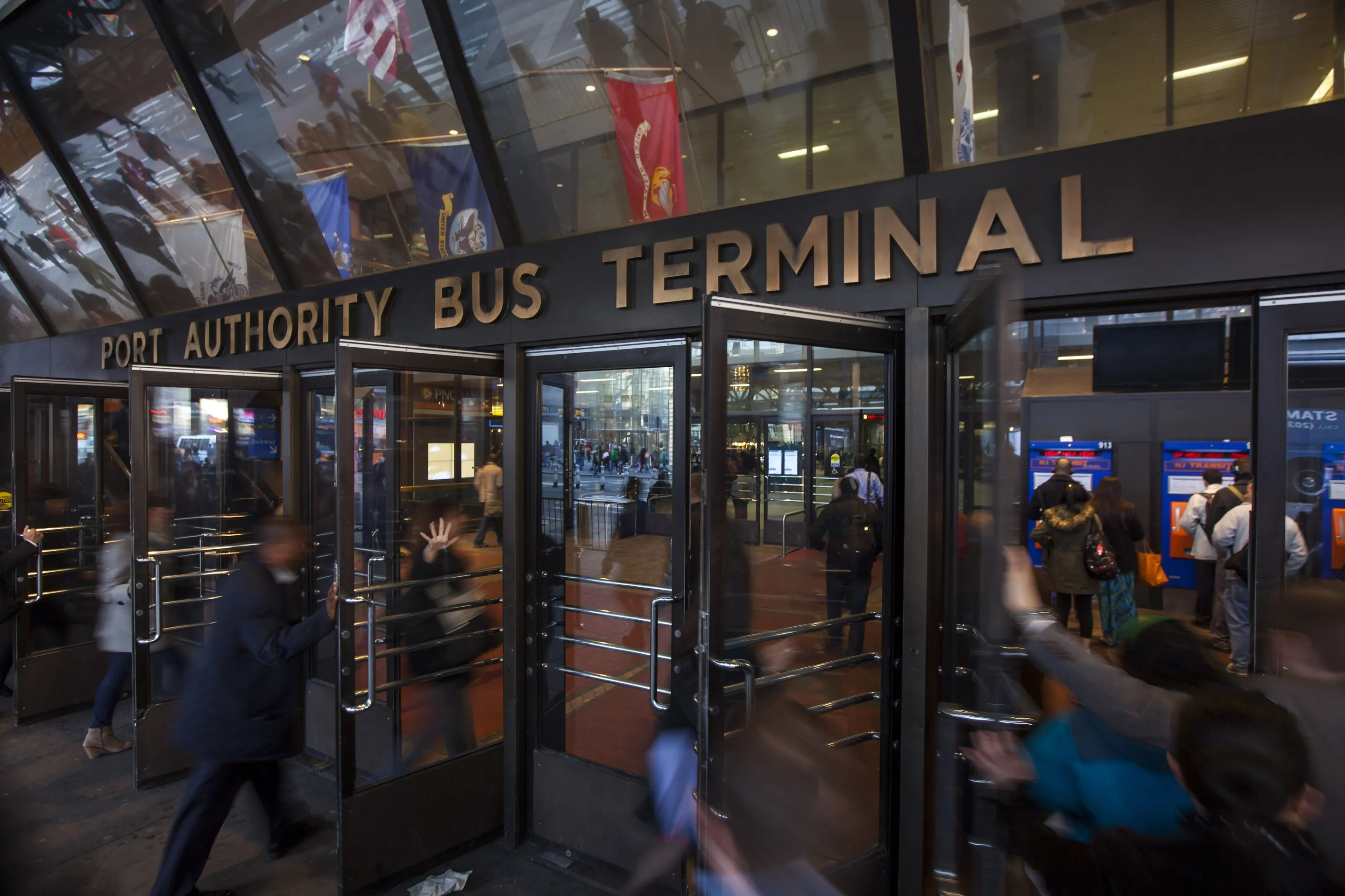 Commuters enter the Port Authority Bus Terminal in New York.