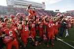 Utah players celebrate at the end of their NCAA college football game against Colorado, in Salt Lake City on Nov. 30, 2013. 
