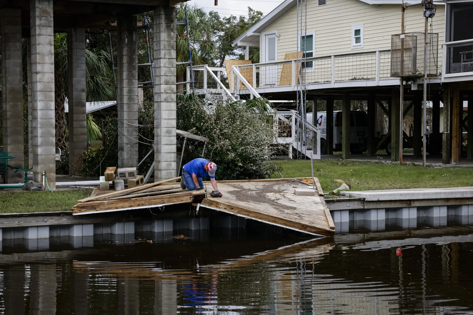 A resident removes debris after Hurricane Idalia hit&nbsp;Horseshoe Beach, Florida, last August.&nbsp;