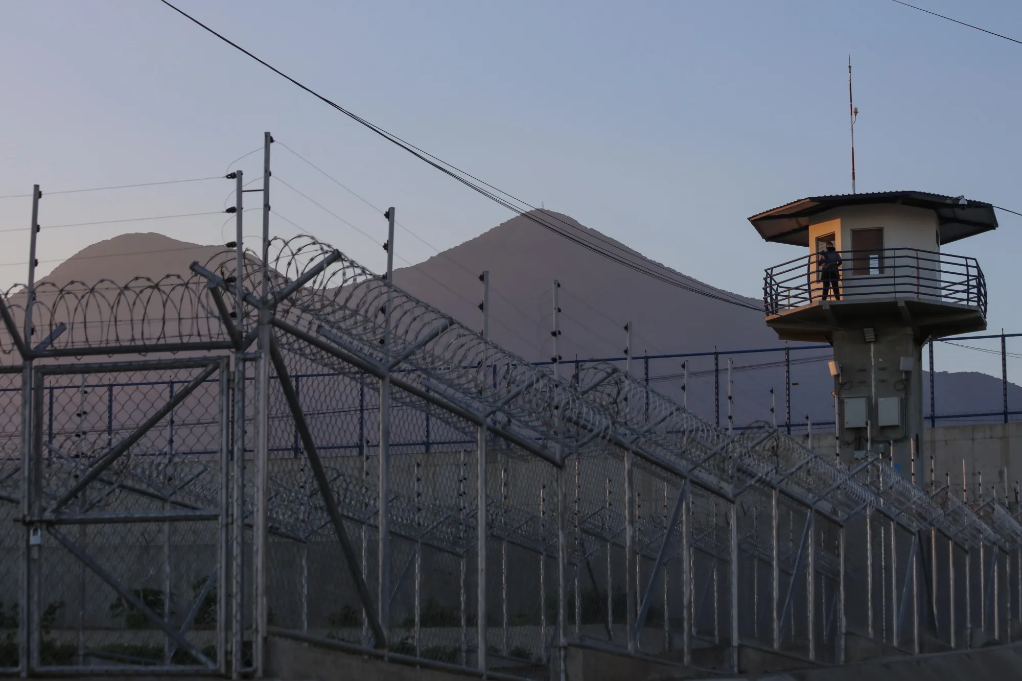 A prison officer stands guard in the watchtower at CECOT in Tecoluca, El Salvador, on April 4.&nbsp;