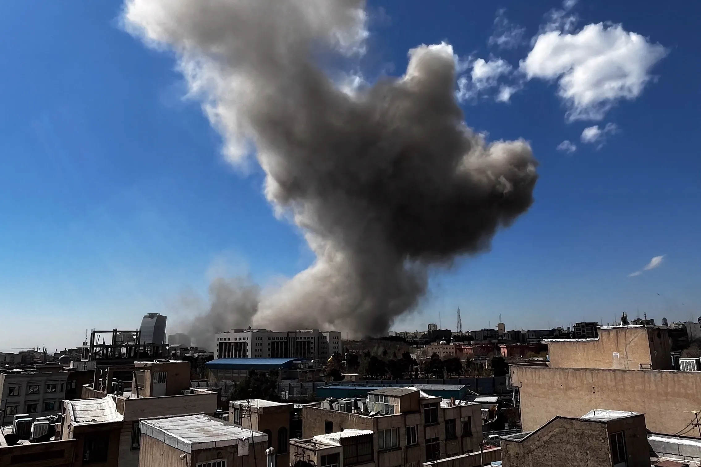 Plumes of smoke rise following explosions in Tehran on March 1, 2026.