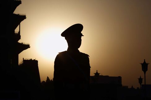 A paramilitary police officer stands guard outside Tiananmen Square ahead of the closing session of the third session of the 12th National People's Congress in Beijing on March 15, 2015.