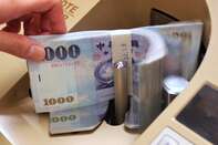 A clerk counts Taiwan 1000 dollar notes