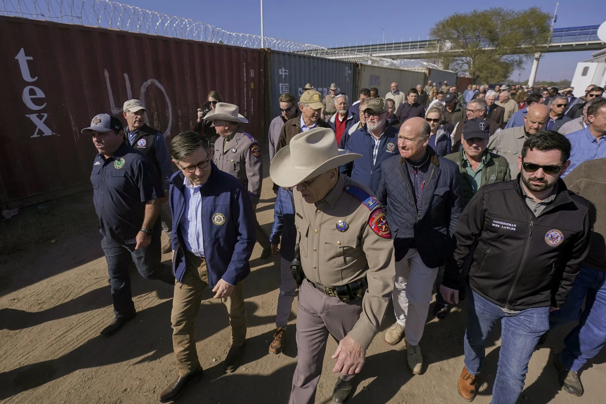 Mike Johnson, center left, and Texas Department of Public Safety chief Steve McCraw, center right, lead a group of Republican members of Congress during a tour of the Texas-Mexico border on Jan. 3.