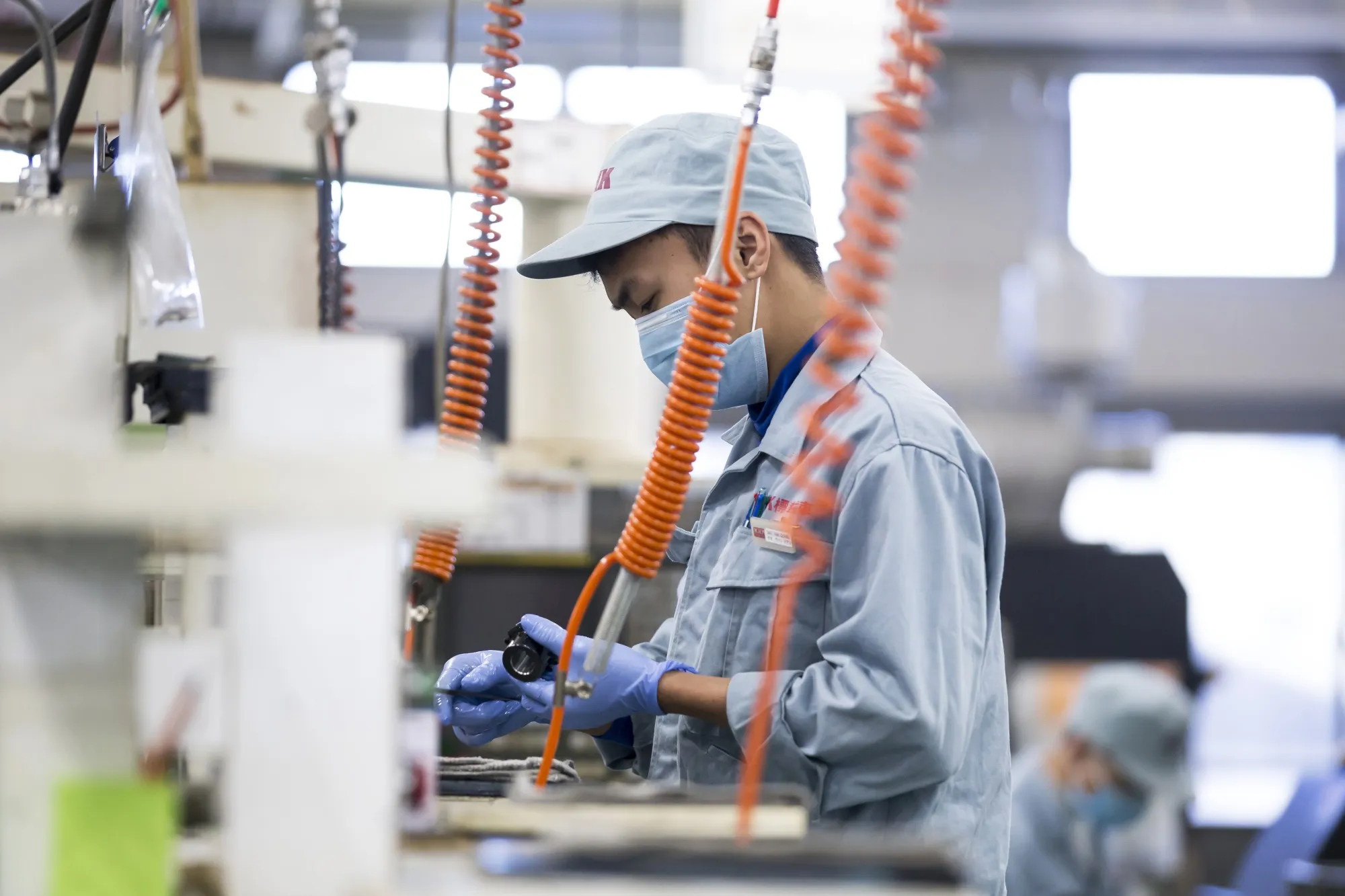 An employee works on the production line of a factory in Kawaguchi, Japan.