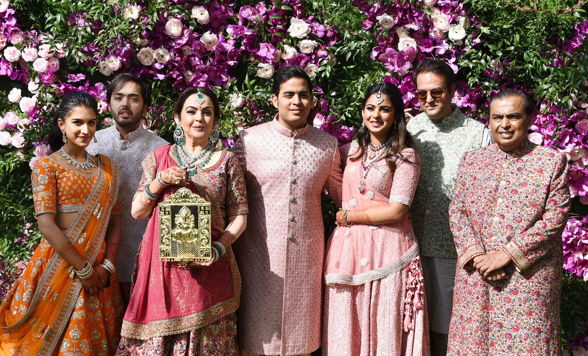 From right, Mukesh Ambani, Anand&nbsp;Piramal, Isha’s husband, Isha, Akash, Nita, Anant, and Anant’s&nbsp;partner Radhika Merchant, at Akash’s wedding ceremony in Mumbai, on March 9, 2019.