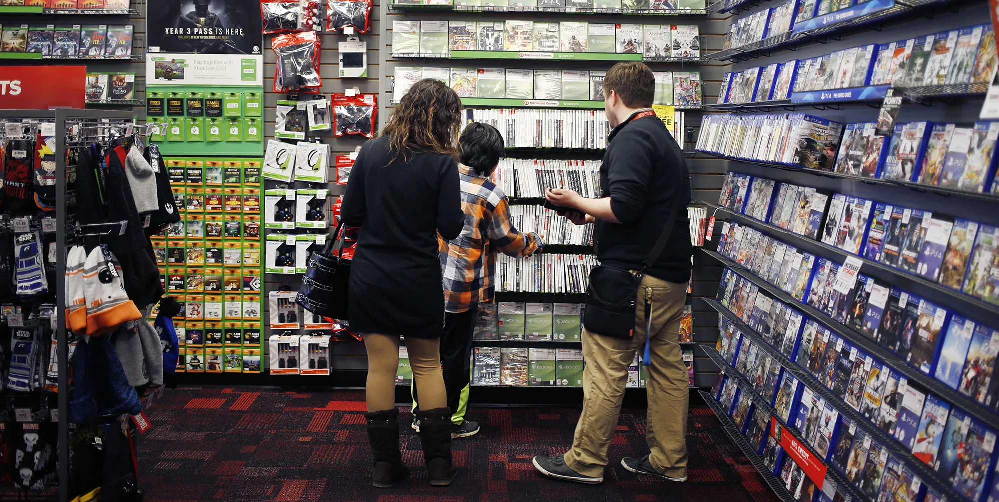 An employee assists customers inside a GameStop store in Louisville, Kentucky.