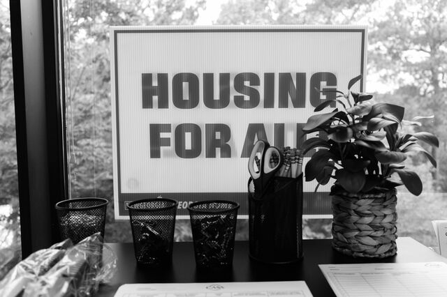A "Housing For All" sign at the workplace of Ovares. 