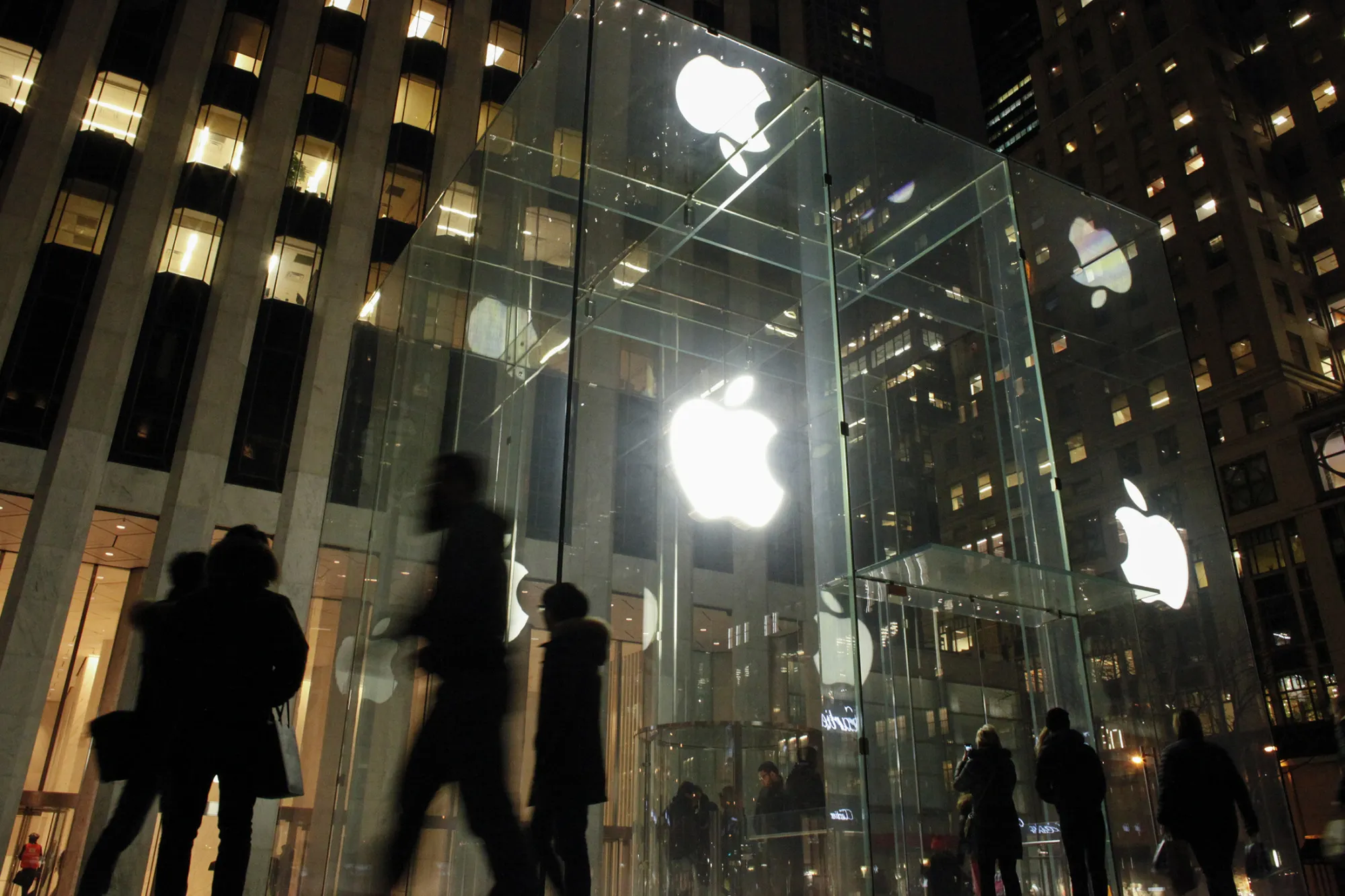People walk outside the Apple store on the Fifth Avenue in New York on Feb. 17, 2016.
