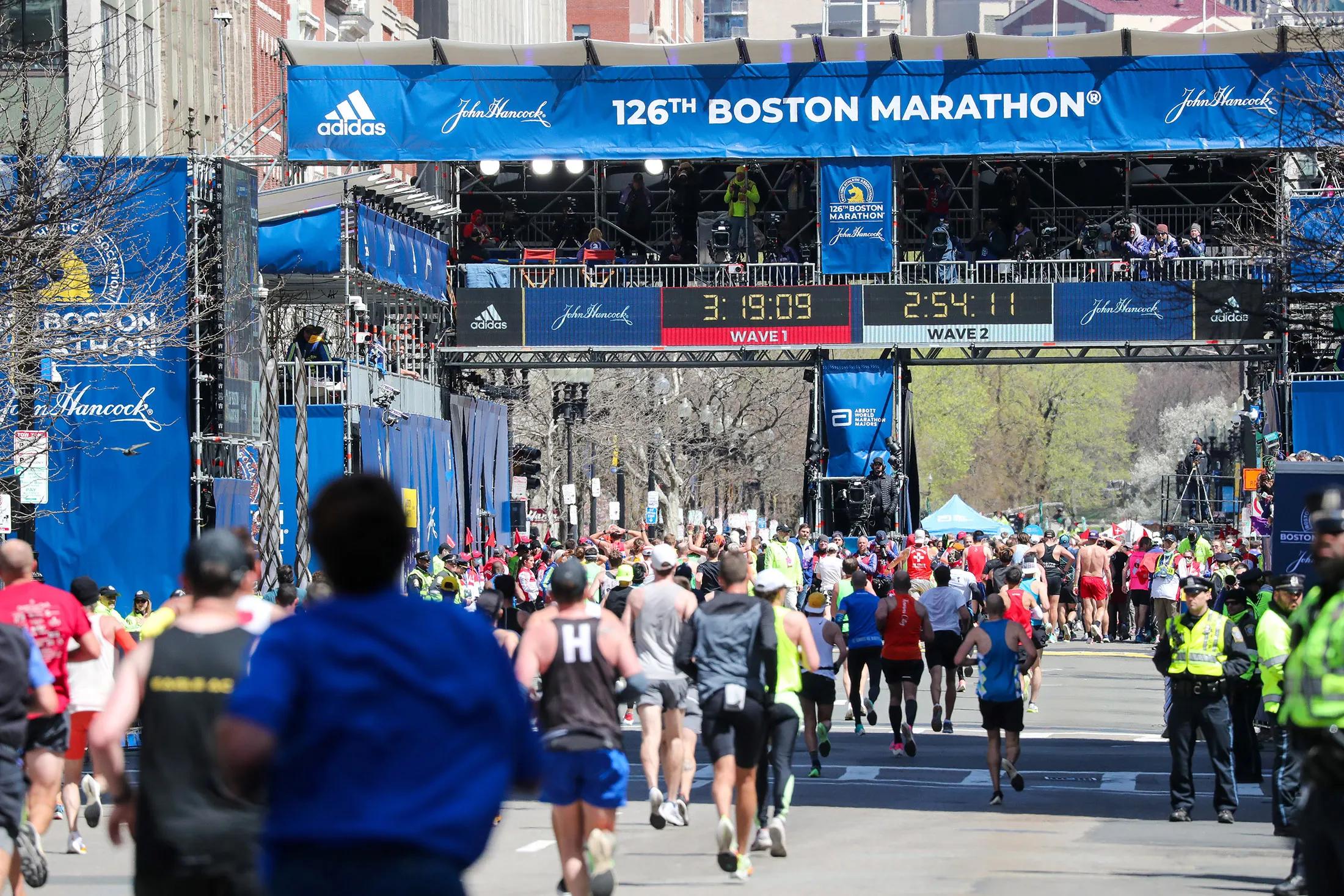 Runners arrive at the finish line of the 126th Boston Marathon in 2022.