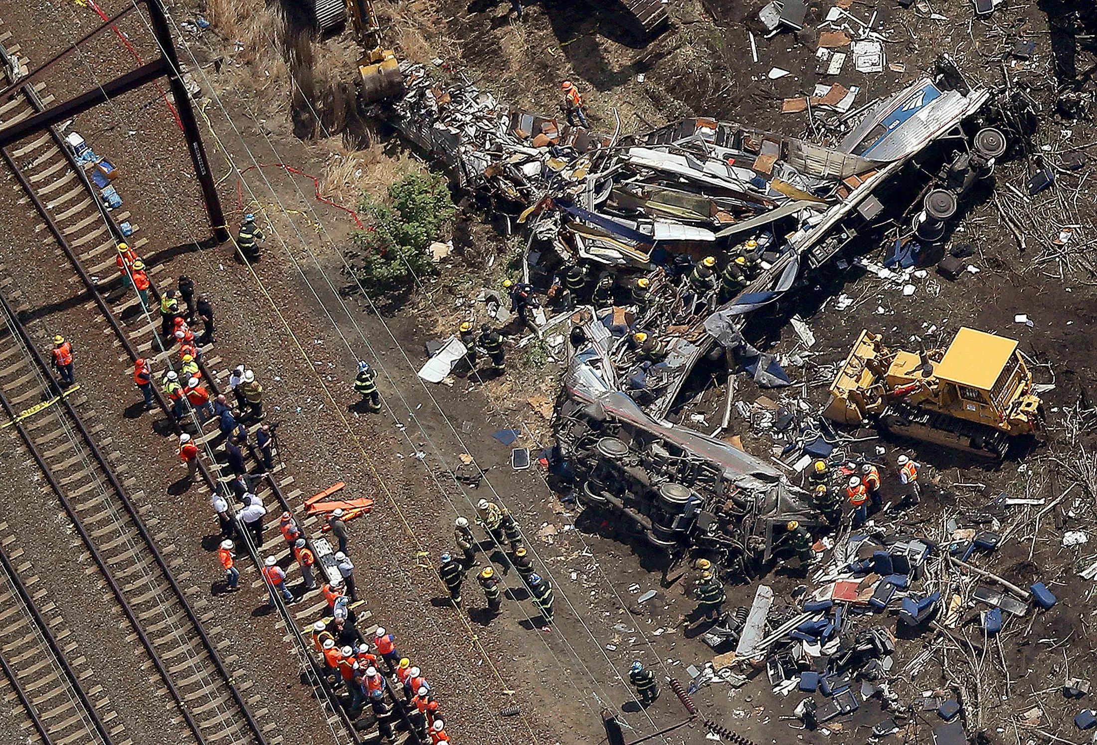 Investigators and first responders work near the wreckage of the crash on May 13, 2015 in north Philadelphia, Pennsylvania.
