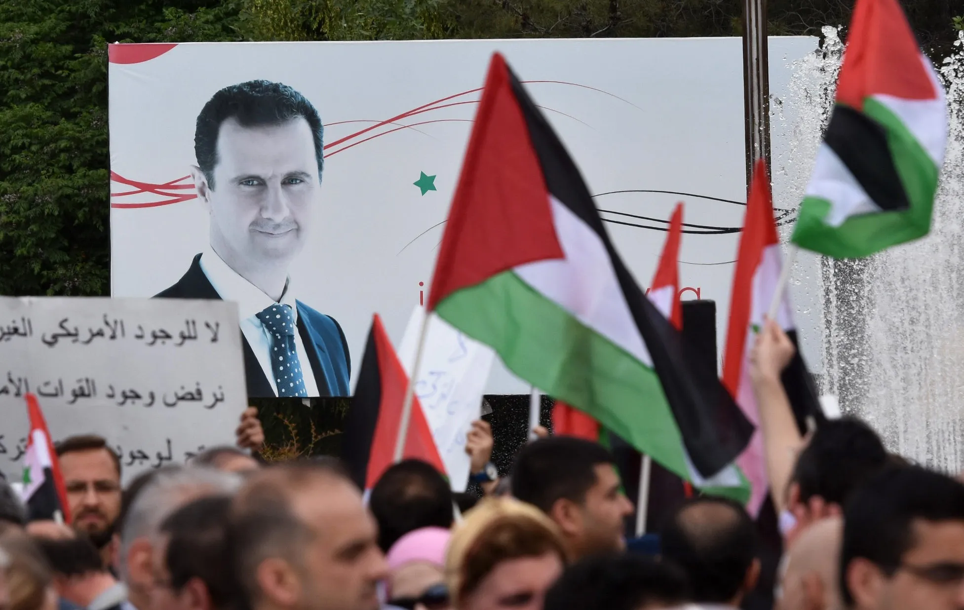 Syrian supporters of President Bashar al-Assad gather in the northern city of Aleppo in&nbsp;April 2018.