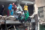 Rescue workers and volunteers remove clothing garments as they search for victims amongst the collapsed Rana Plaza building in Dhaka, Bangladesh, on April 26