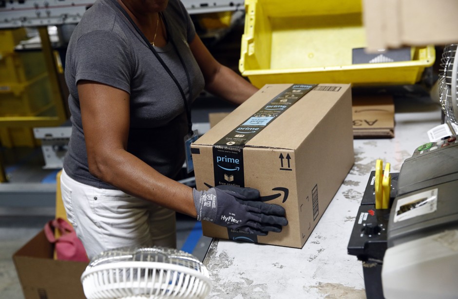 A worker at an Amazon fulfillment center in Baltimore. Amazon is boosting its minimum wage for all U.S. workers to $15 per hour starting next month.