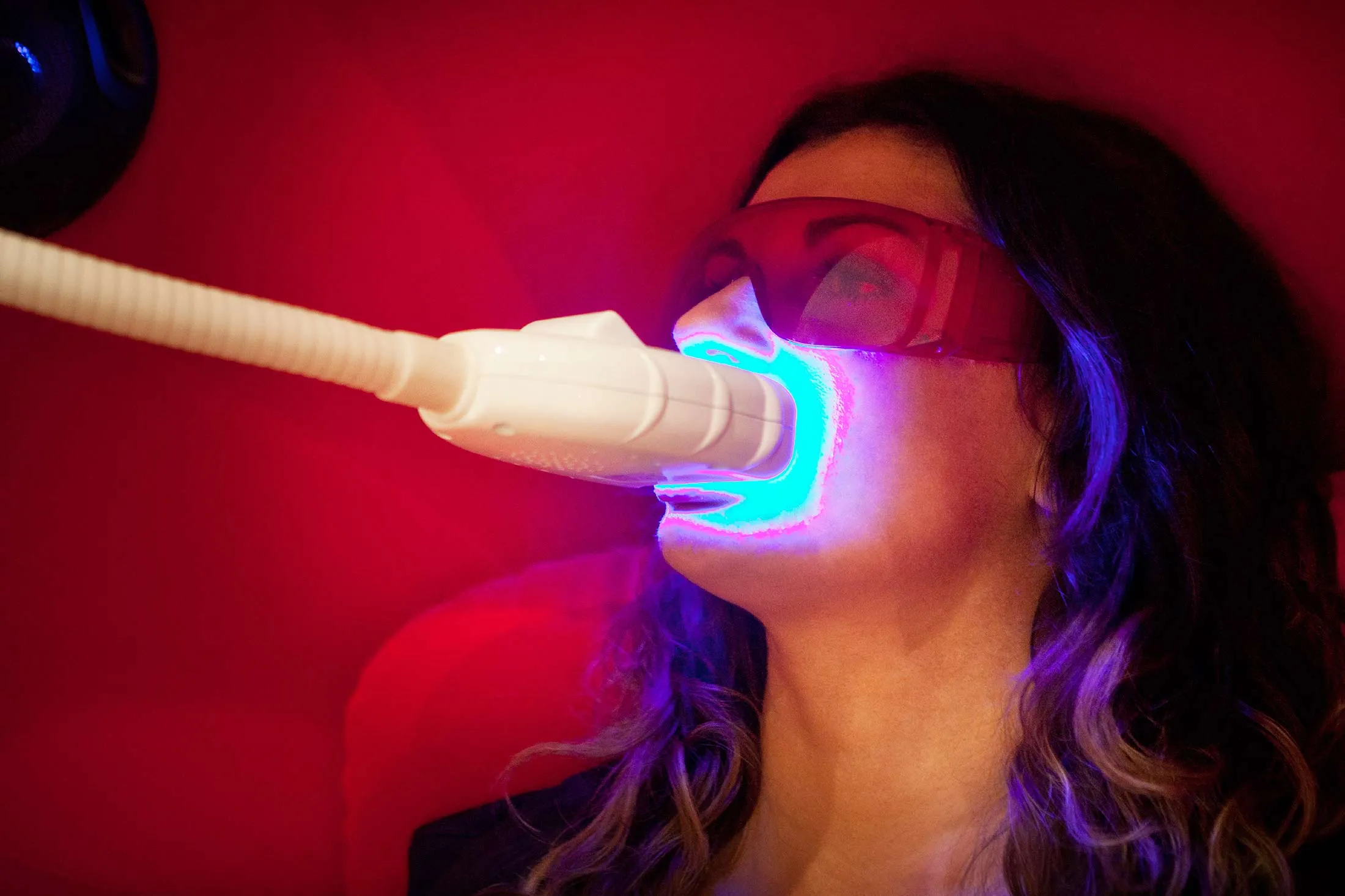 Reportage in a smile bar in Paris, France. Teeth whitening involves applying a whitening paste using a special mouthpiece, then exposing the teeth to a LED lamp which sets off the whitening process.