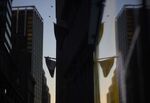 An American flag is reflected in the window of a building near the New York Stock Exchange.