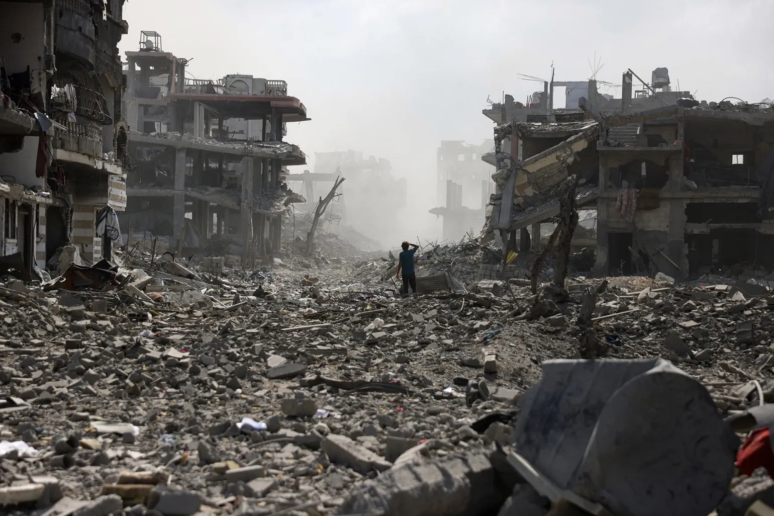 A Palestinian youth stands on a street strewn with rubble following an explosion in the Saftawi neighbourhood in the northern Gaza Strip on Aug. 25.&nbsp;