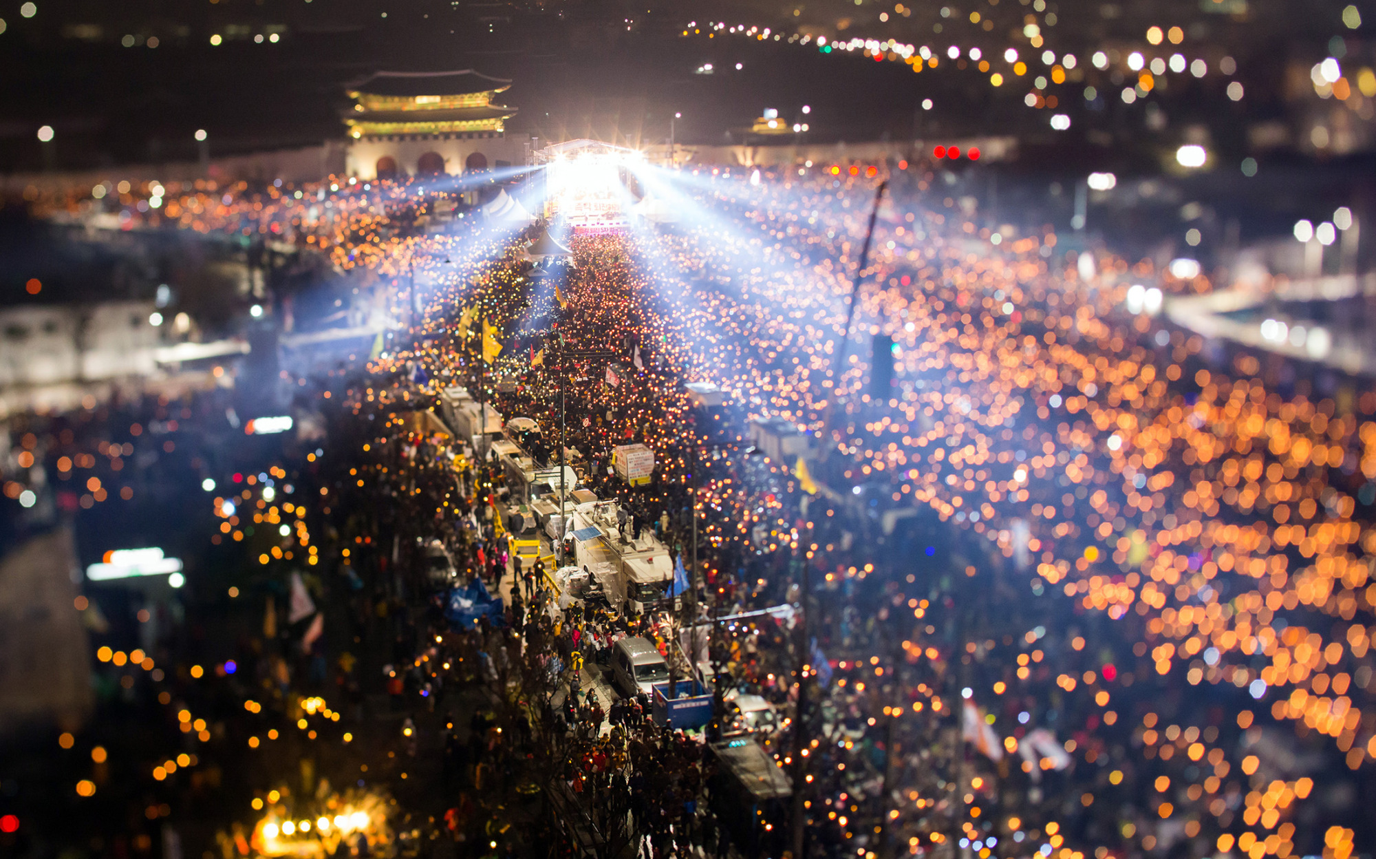 Light shines from a stage as protesters gather in Gwanghwamun square during a candlight rally in Seoul, on Nov. 26, 2016.

