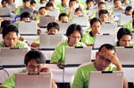 Indonesian students work during a regional hacking competition in Denpasar, Bali, Indonesia, in 2007. Photographer: Made Nagi/EPA