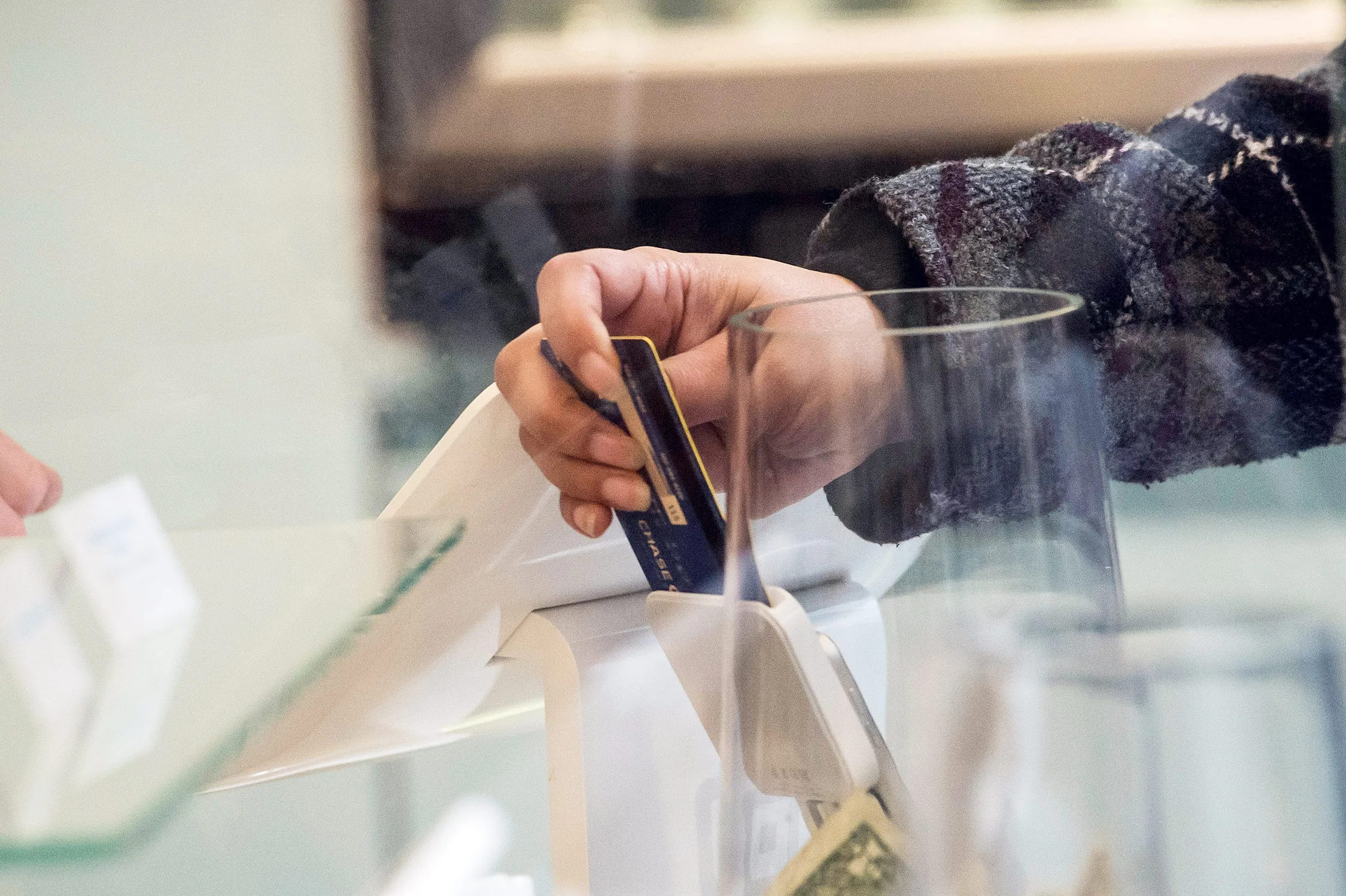 A customer inserts a credit card into Square Inc. device while making a payment in San Francisco, California.