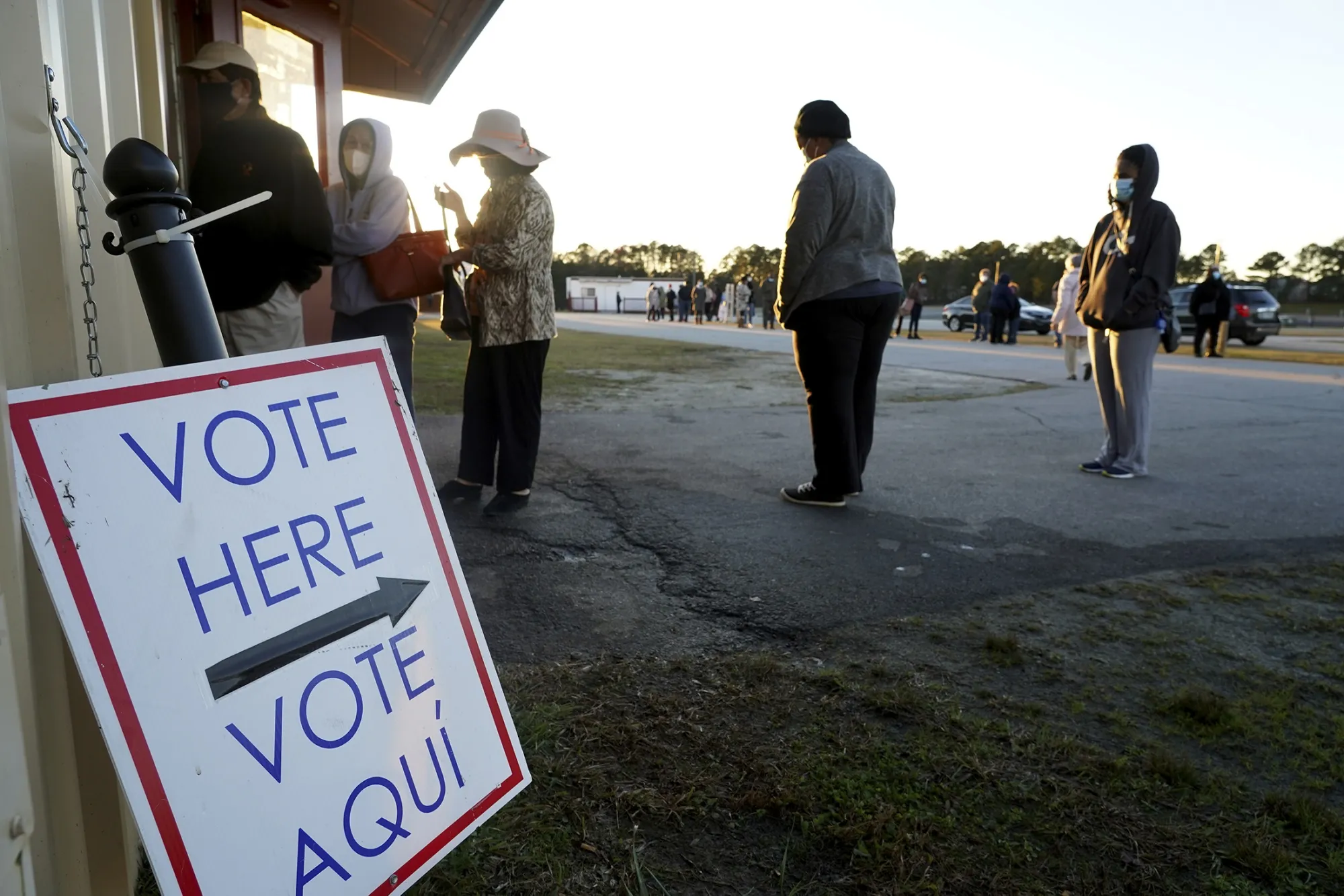 Voters stand in line to cast their ballots during the first day of early voting in the U.S. Senate runoff in Atlanta, Georgia.