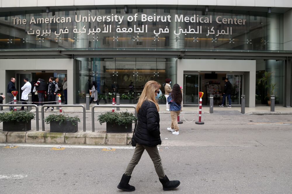 A pedestrian wearing a protective face mask walks past the American University of Beirut Medical Center (AUBMC) in Beirut, Lebanon.