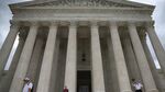 Tourist visit the Supreme Court Building as a guard stands watch on Aug. 20, 2014 in Washington.
