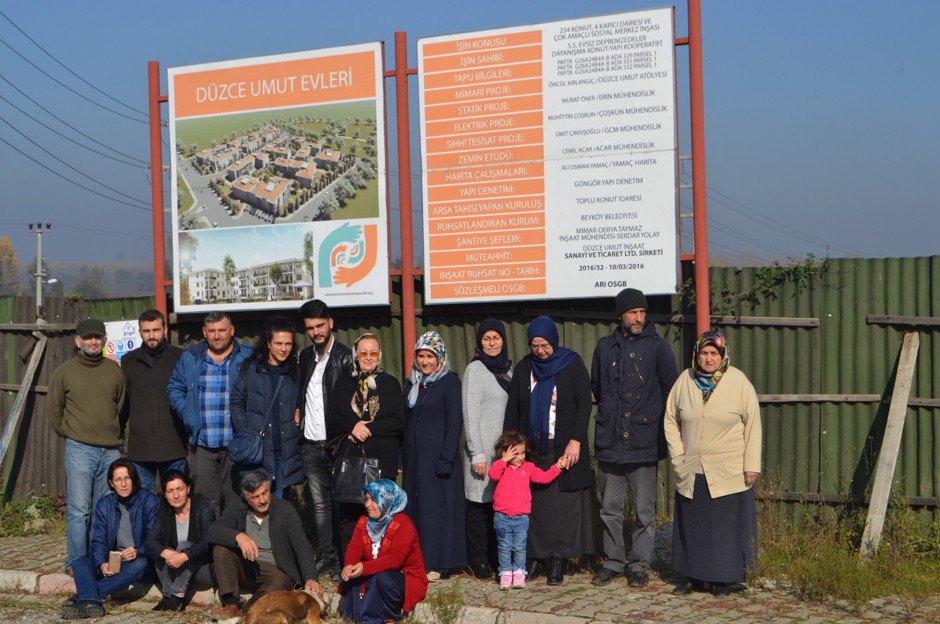 Members of the Düzce Solidarity Housing Cooperative at the project site, including Sami Kılıç (center, with dog) and Safiye Alkaya (second row, in gray cardigan) 