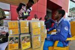 Sim card sellers for MTN Group Ltd. mobile network wait for customers at a roadside kiosk in Lagos