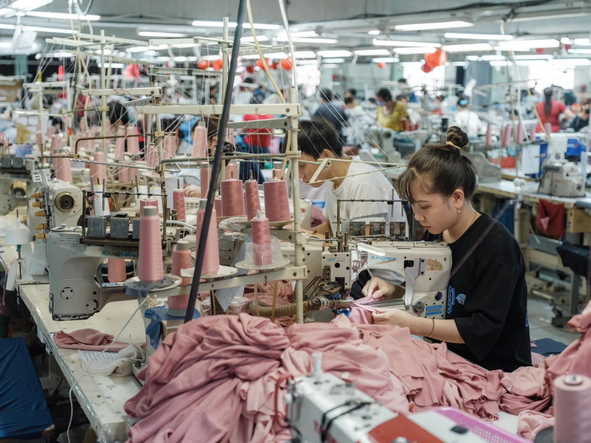 Workers operate sewing machines at a garment factory in Binh Thuan province, Ho Chi Minh City, Vietnam.