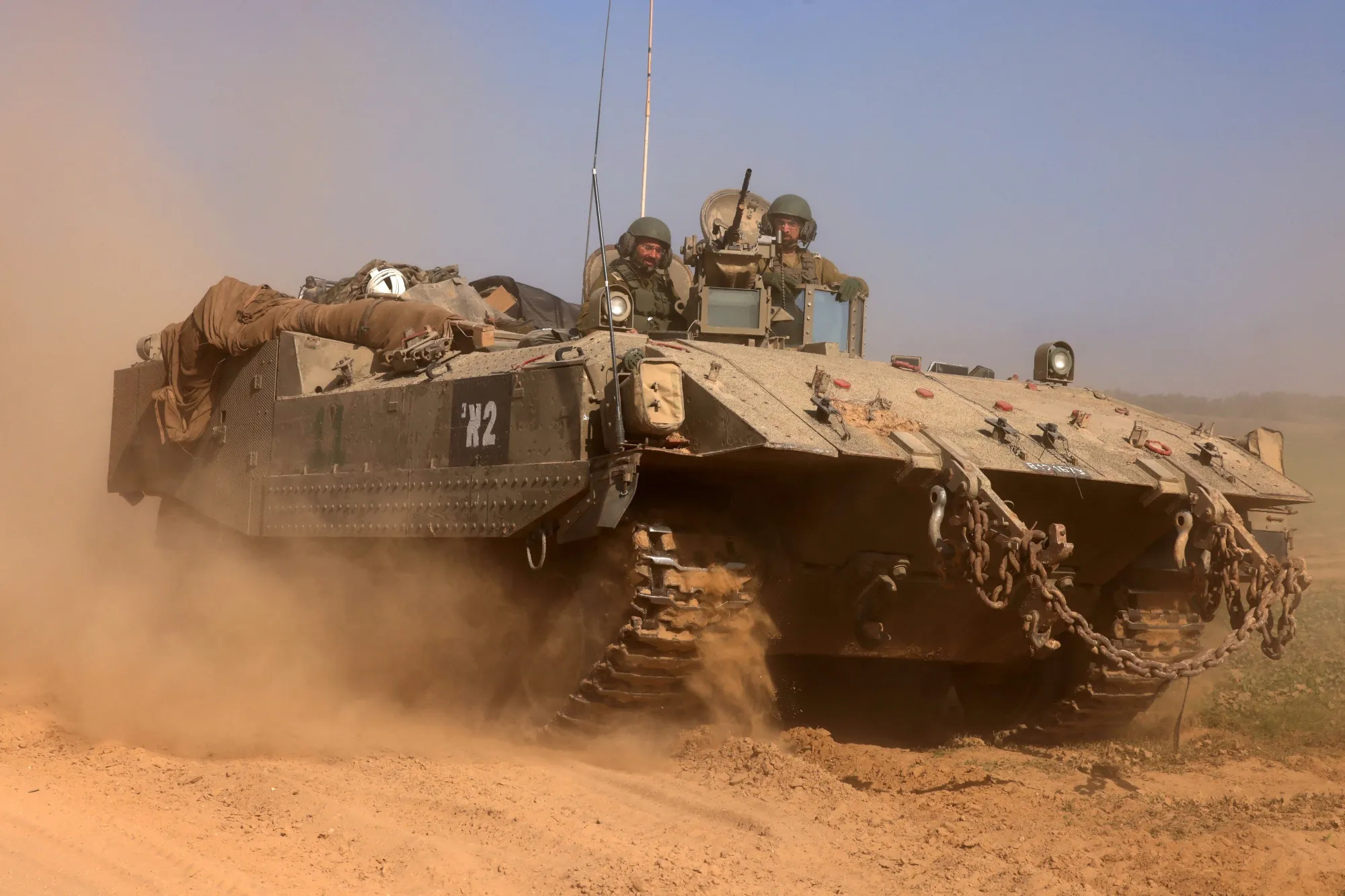 Israeli soldiers on an armoured personnel carrier&nbsp;rolling back from the Gaza Strip.