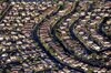 Rows of houses stand in Las Vegas, Nevada, U.S., as seen in this aerial photo taken on Tuesday, Sept. 22, 2009. The median home price in the Las Vegas area fell 40 percent to a 10-year low in August as sales of foreclosed properties cut the value of single family houses and condominiums, MDA DataQuick said.