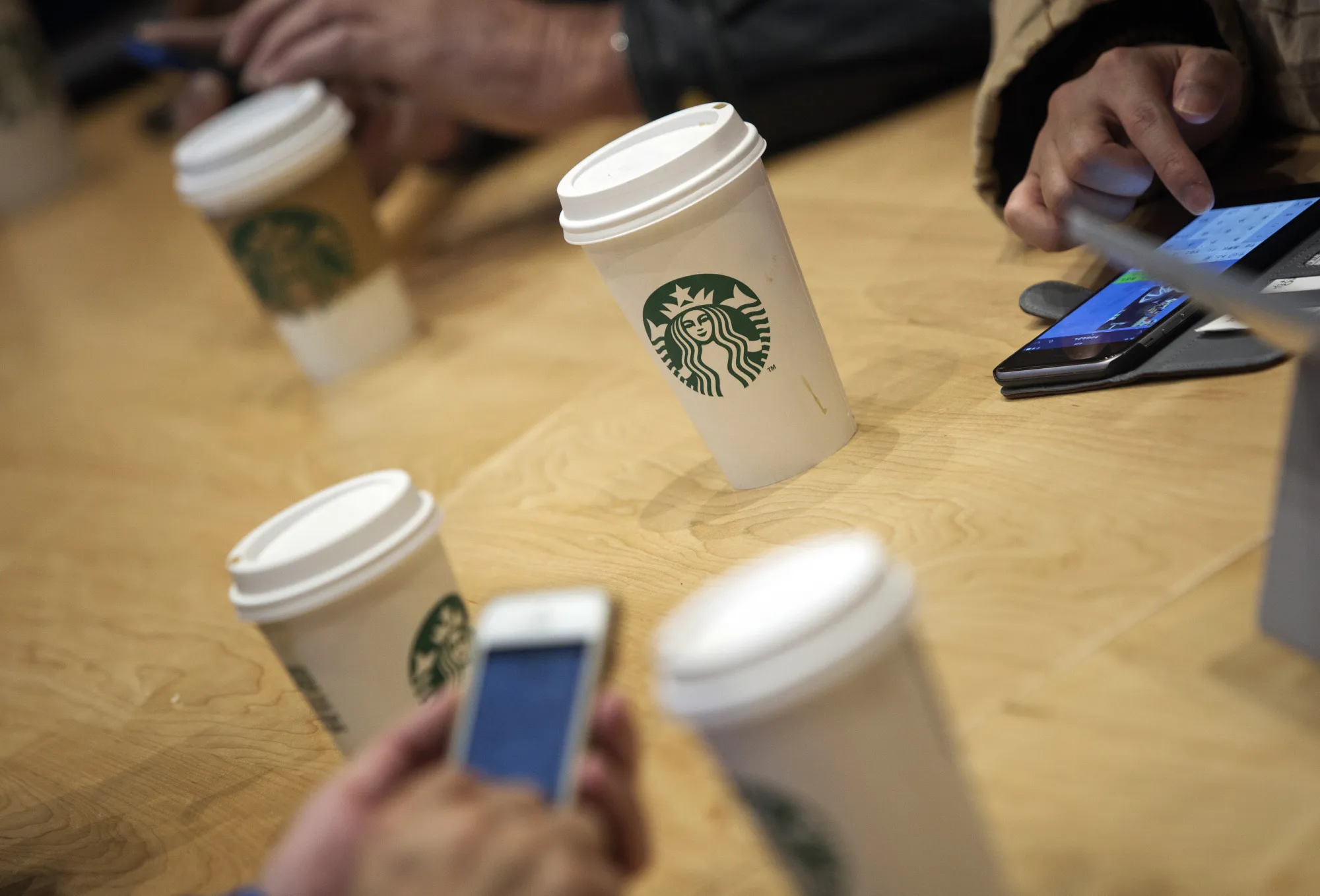 Beverages sit on a table inside a Starbucks Corp. coffee shop.
