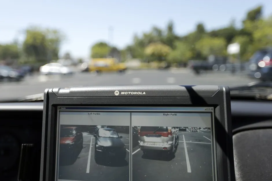 San Diego County Deputy Sheriff Ben Chassen drives a police car fitted with technology that reads the license plates.