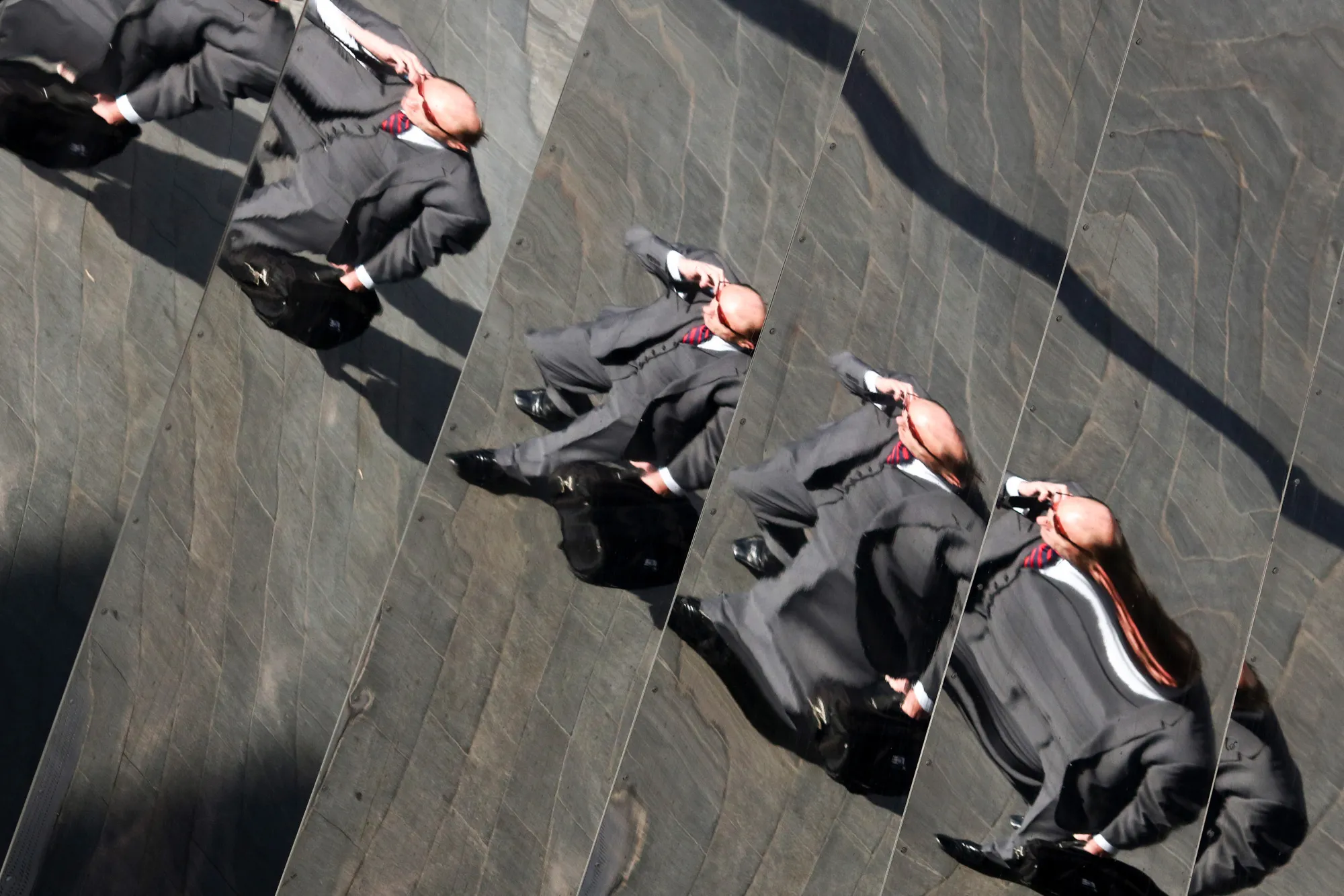 The mirrored exterior wall of Birmingham New Street station reflects a businessman talking on a mobile phone in Birmingham, U.K., on Tuesday, Oct. 4, 2016. U.K. consumers appear to be shrugging off some initial Brexit concerns as their worst fears about the economy are allayed.