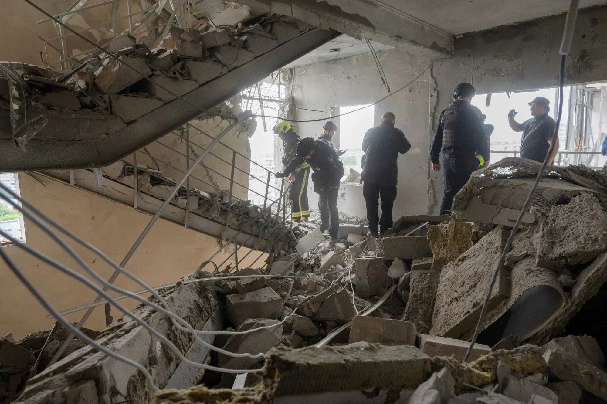Rescuers from the State Emergency Service of Ukraine inspect the damage following a Russian missile attack In Kharkiv on May 14.