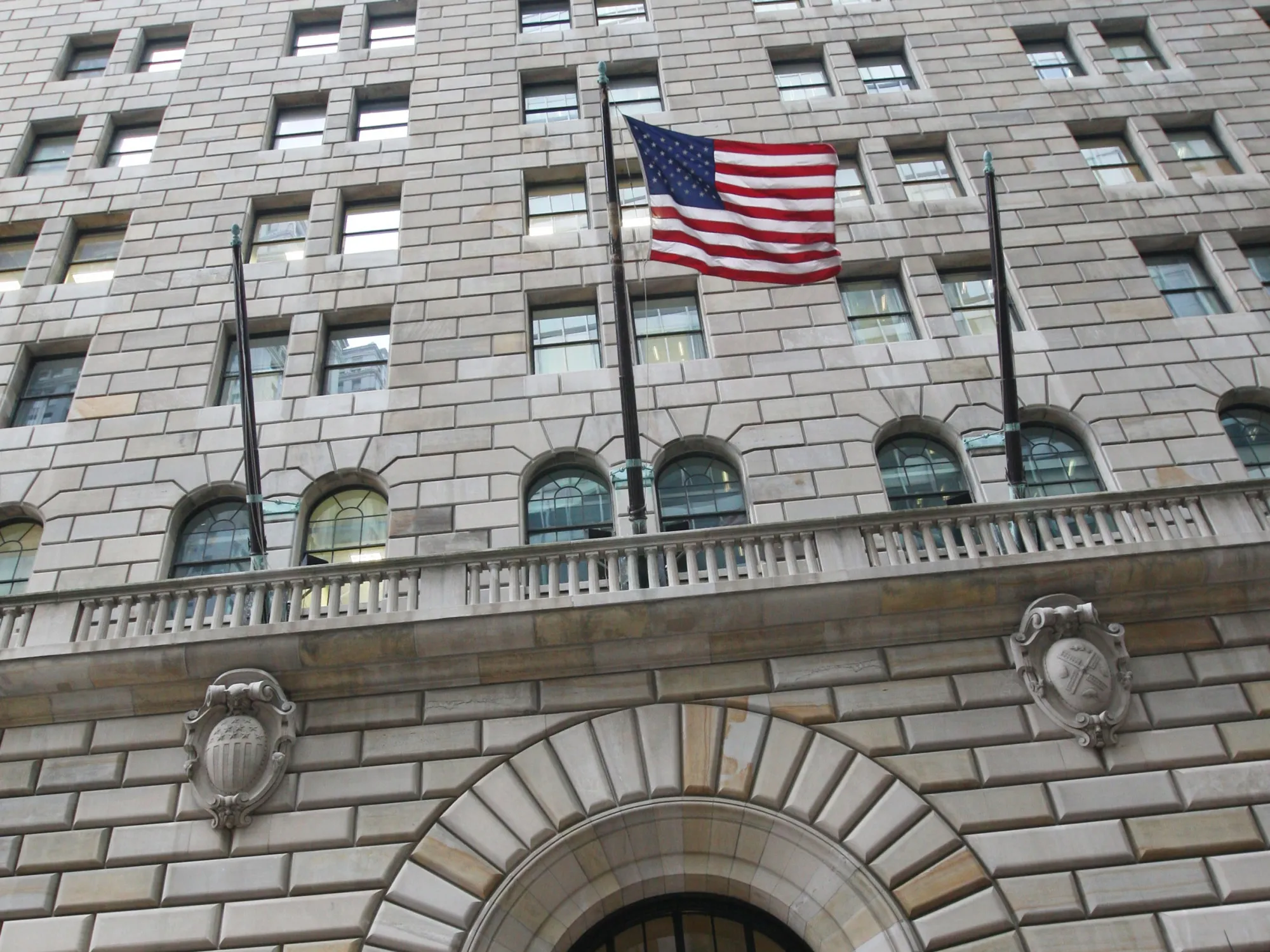 The U.S. flag hangs on the facade of the Federal Reserve Ban