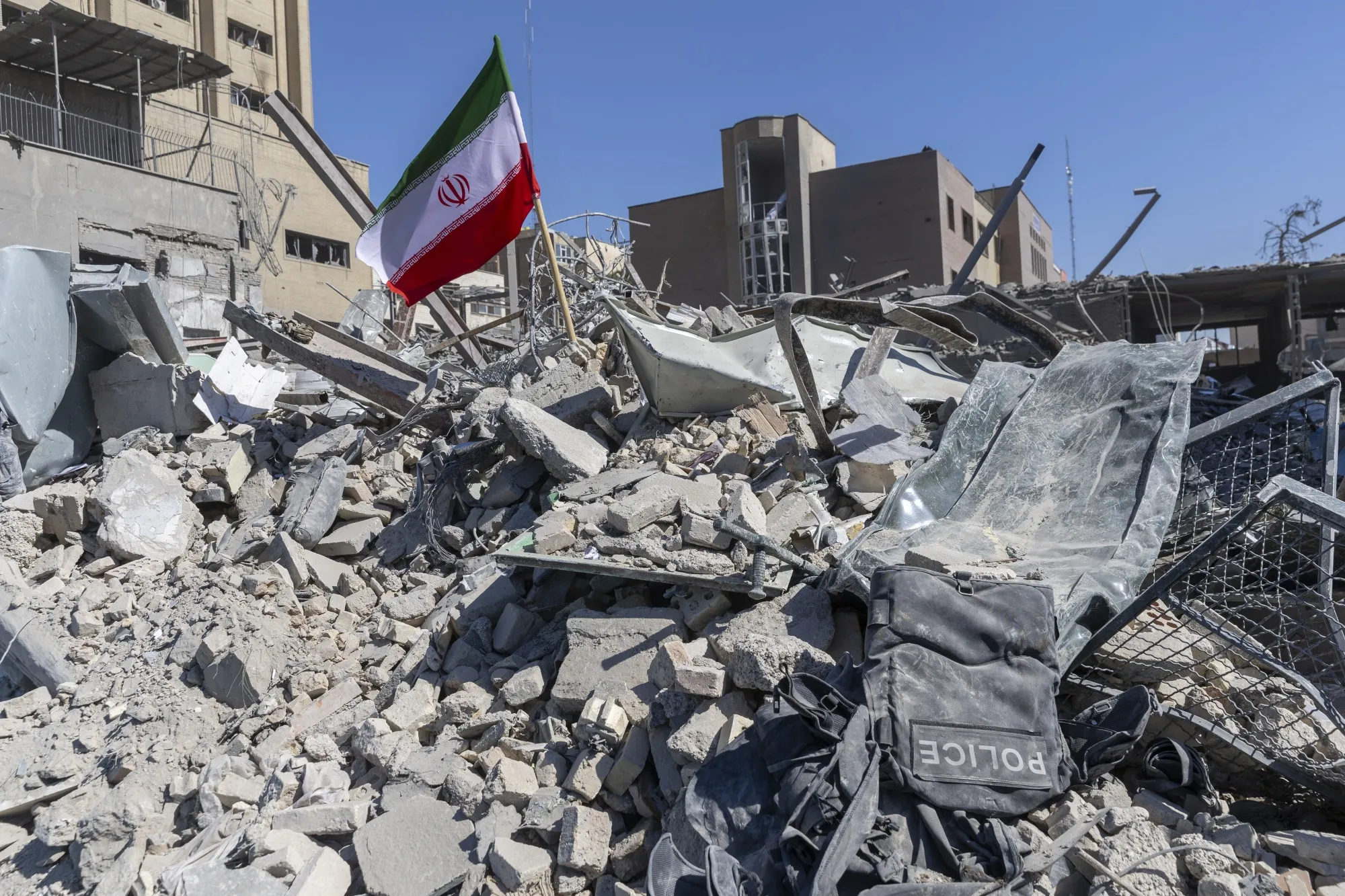 An Iranian flag is planted in the rubble of a police station on March 3 in Tehran.