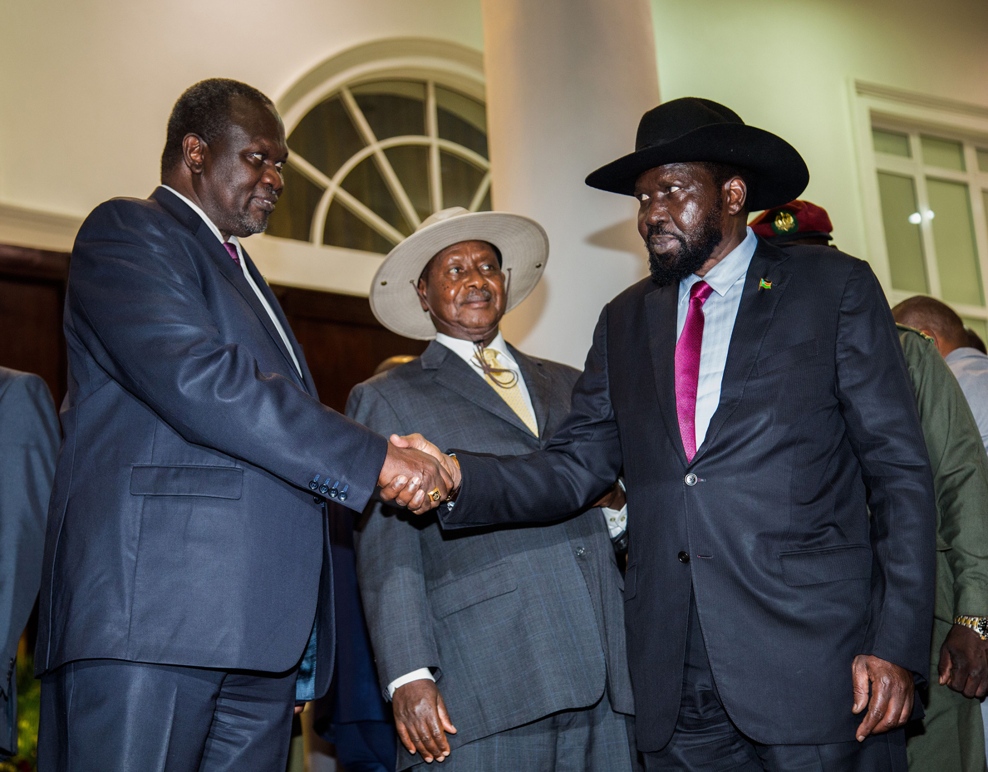 Salva Kiir, right, shakes hands with&nbsp;Riek Machar during peace talks in Uganda on July 7, 2018.