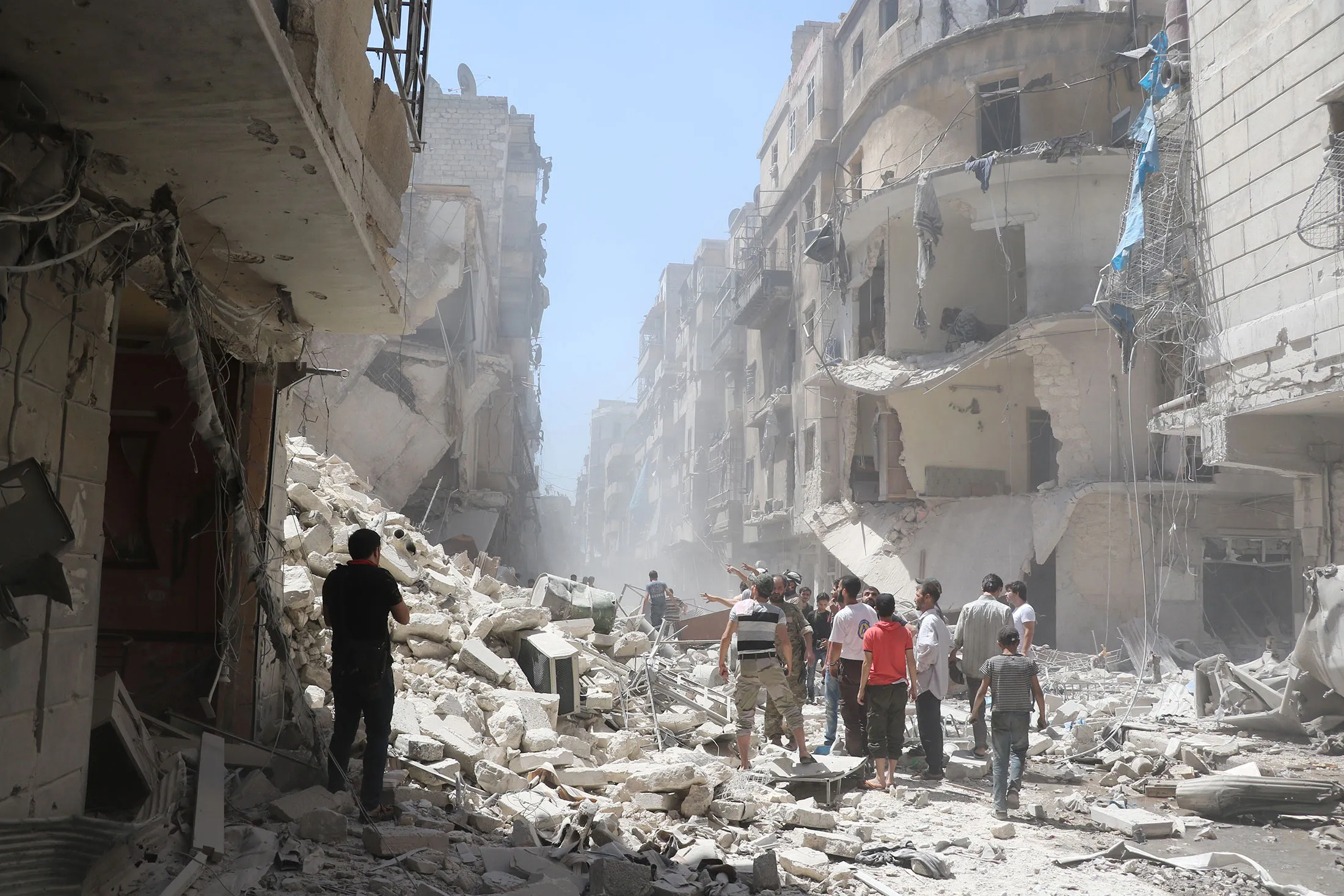 Syrians inspect the damage after Asad Regime forces' attack on opposition controlled Meshed region in Aleppo, Syria on July 26, 2016.
