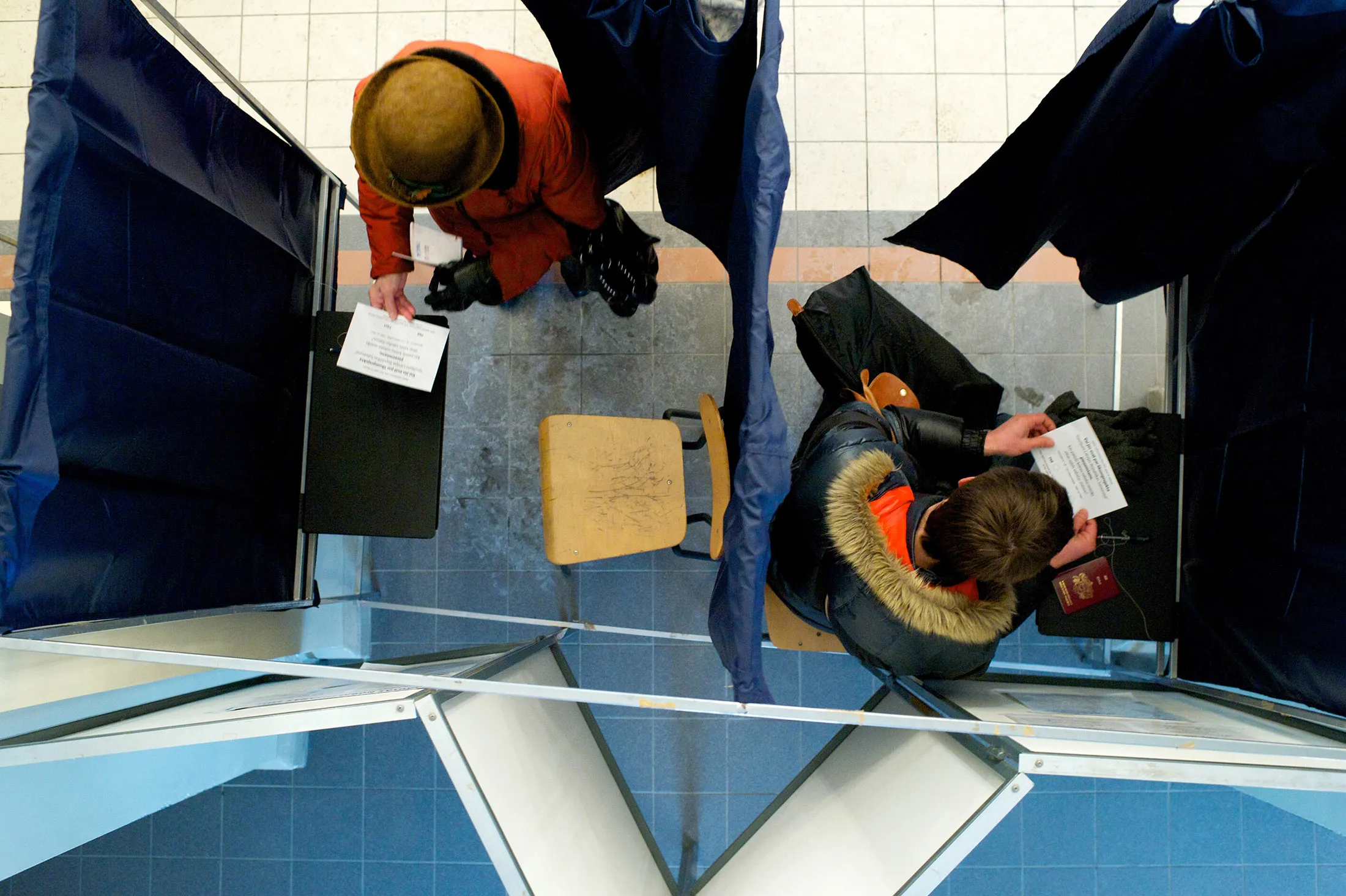 People prepare to cast their ballots at