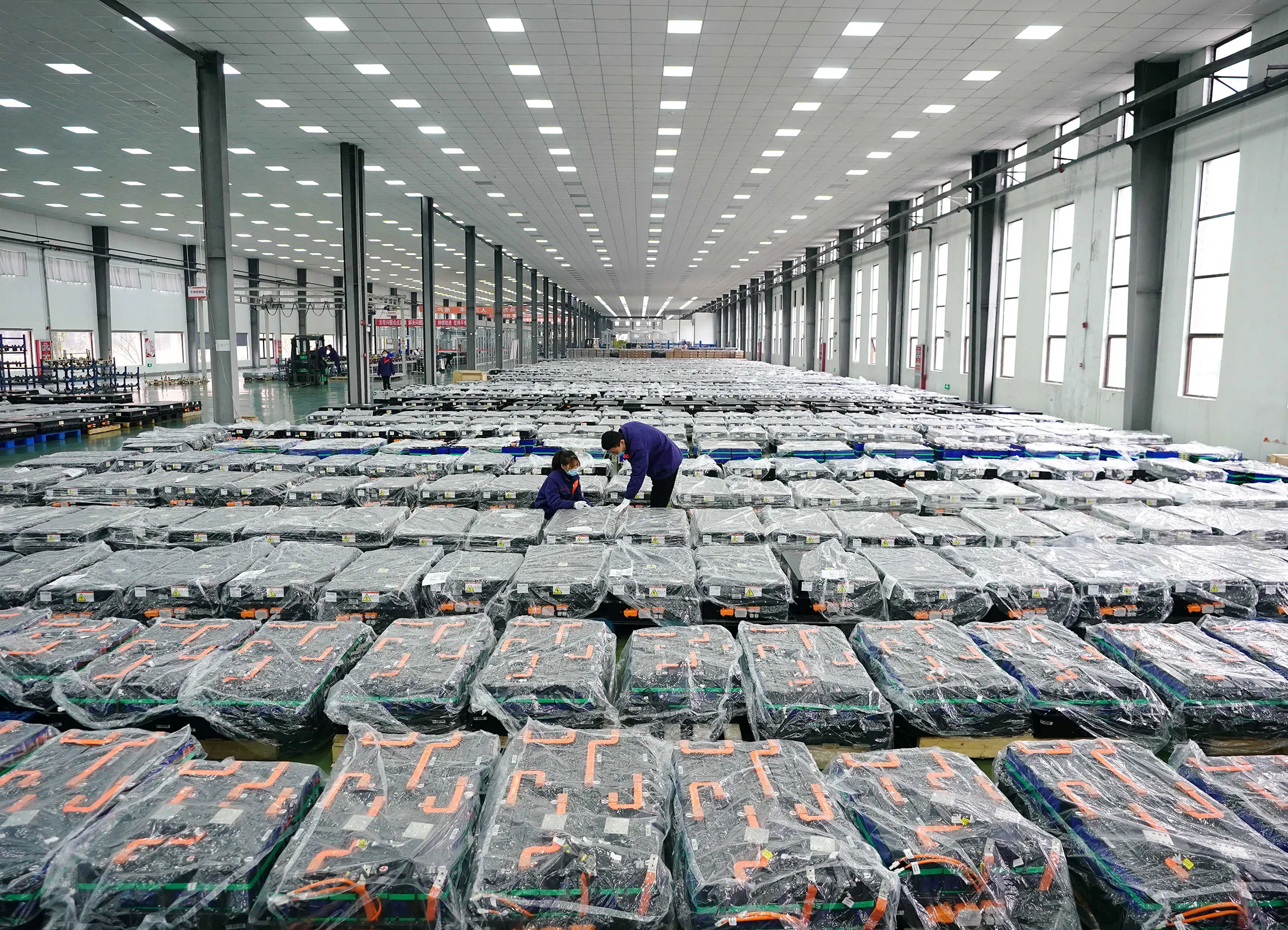 Workers check products at a lithium battery factory in Tangshan, China.