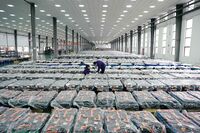 Workers check products at a lithium battery factory in Tangshan, China.