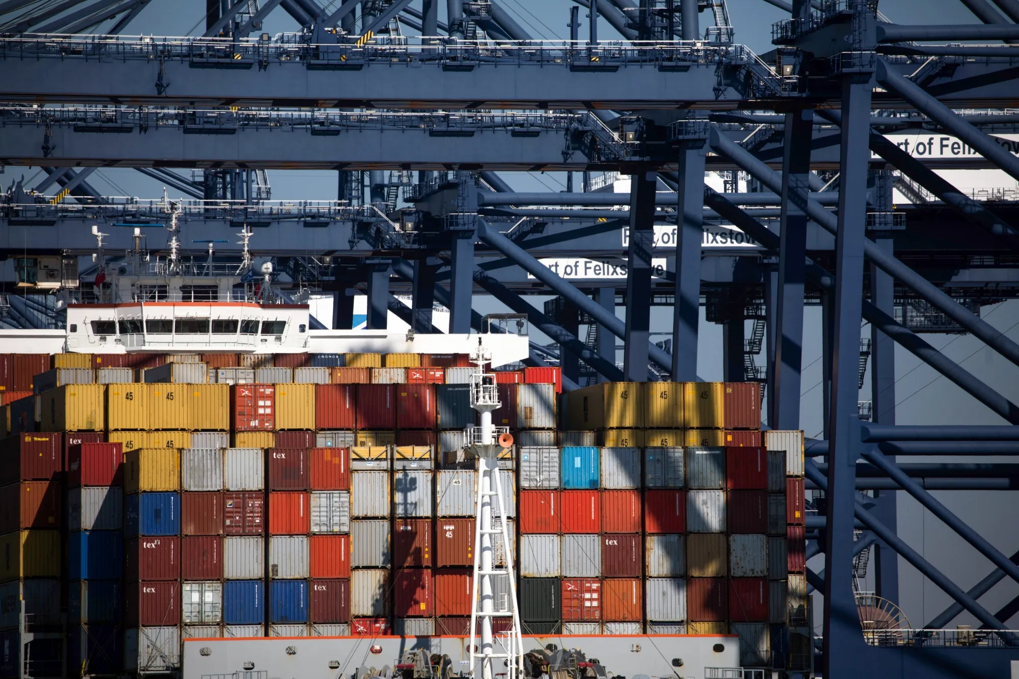 Shipping containers sit on top of a container ship on the dockside at the Port of Felixstowe Ltd.,&nbsp;in Felixstowe, U.K.