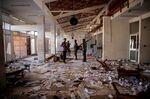 Militia fighters walk in the ransacked terminal at the Lalibela airport in Ethiopia.