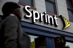 Pedestrians walk past a Sprint Corp. store in Washington, D.C., U.S.