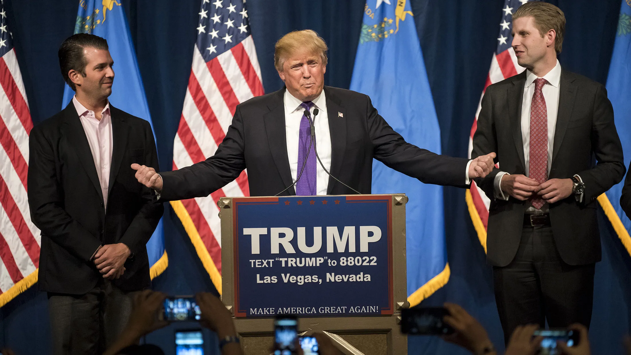 Donald Trump speaks as his sons Donald Trump Jr., left, and Eric Trump, right, listen during a rally in Las Vegas on Feb. 23, 2016.
